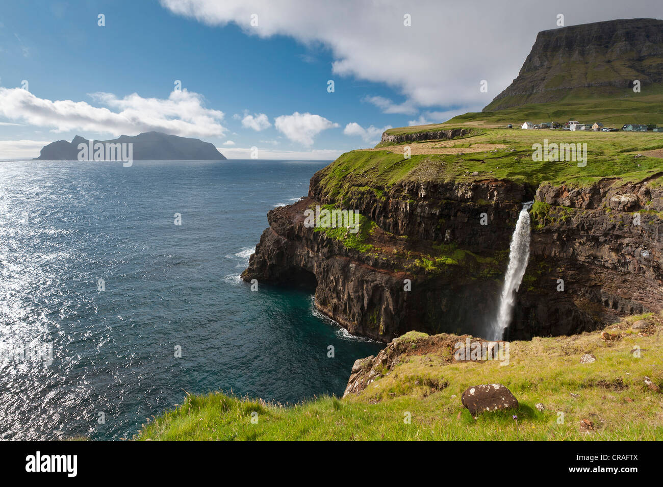 Waterfall into the sea, coast, view towards Mykines Island, Gásadalur, Vágar, Faroe Islands, Denmark, North Atlantic Stock Photo