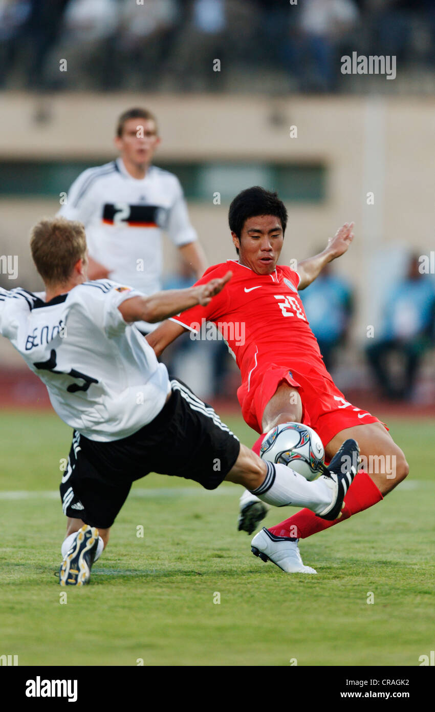 Lars Bender of Germany (L) challenges Hee Seong Park of South Korea (R) during a 2009 FIFA U-20 World Cup match. Stock Photo