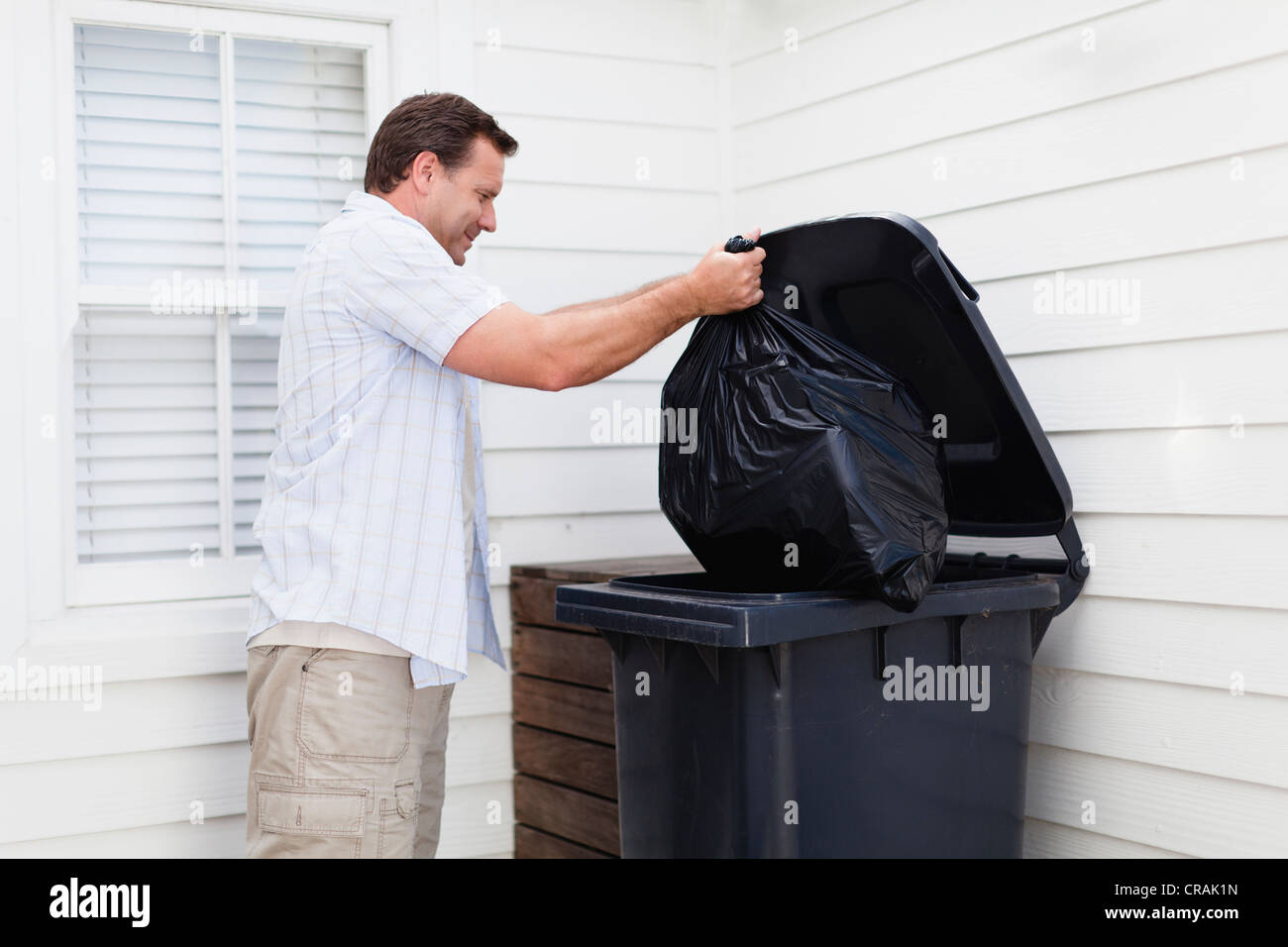 Man taking out garbage Stock Photo