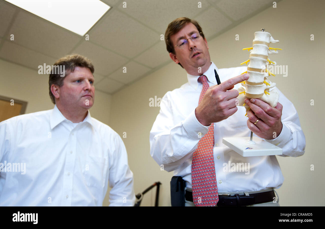 Doctor explains to a patient his back injury Stock Photo - Alamy