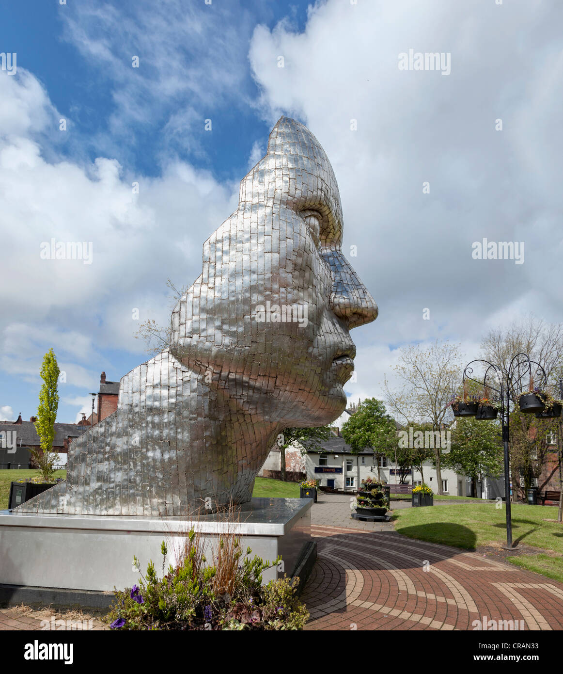 The statue by Rick Kirby entitled the Face of Wigan in the Wiend in the town centre. Stock Photo