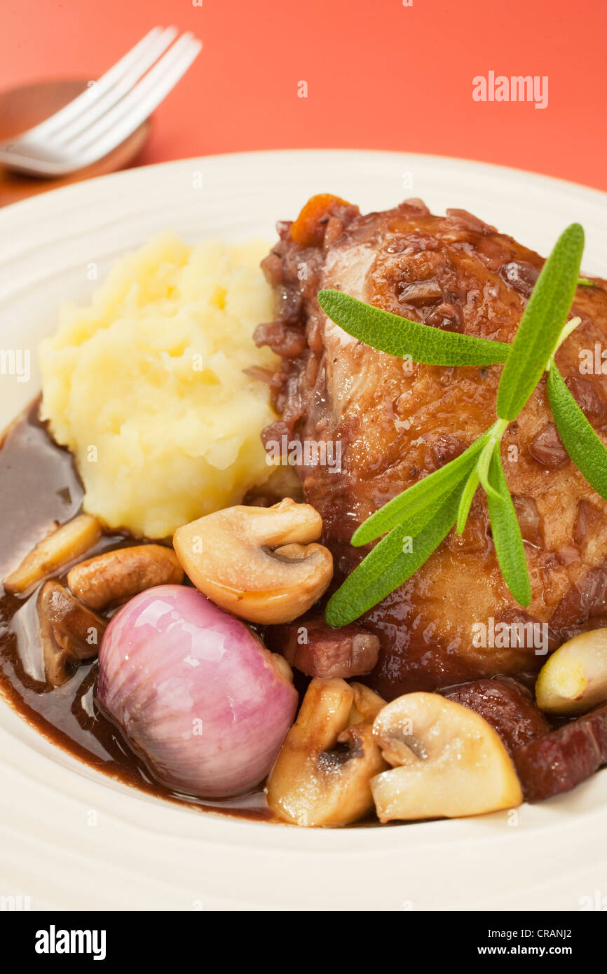 French classic, coq au vin or chicken in red wine with onions, mushrooms and bacon. Perfect for Sunday lunch with mashed potato. Stock Photo