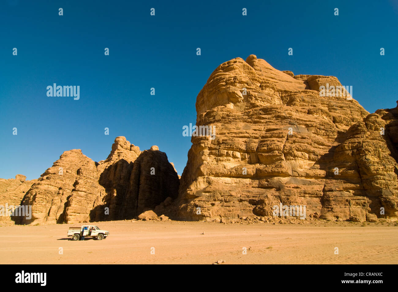 Rocks, an off-road vehicle in front, desert, Wadi Rum, Jordan, Middle East Stock Photo