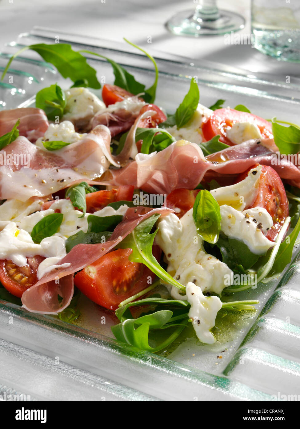 Burrata prosciutto ham and tomato salad Stock Photo Alamy