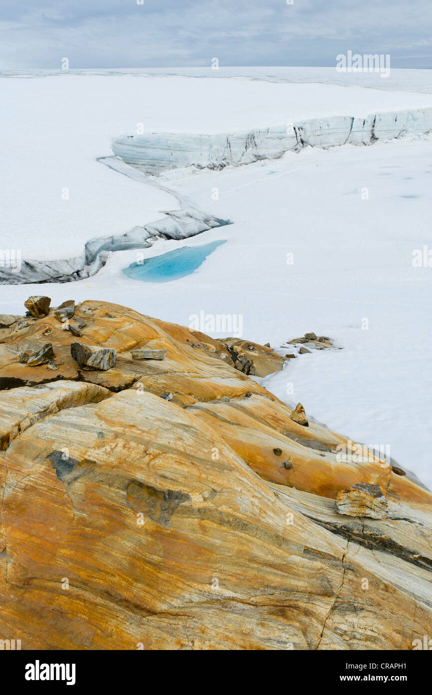 Ocher-colored rock on Mittivakkat Glacier, Ammassalik Island, East Greenland Stock Photo