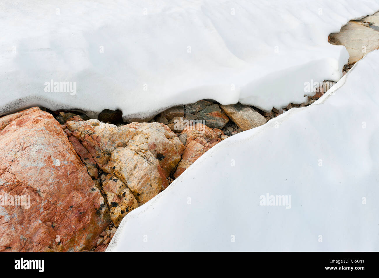 Snow, colourful rock, Mittivakkat Glacier, Ammassalik Island, East Greenland Stock Photo