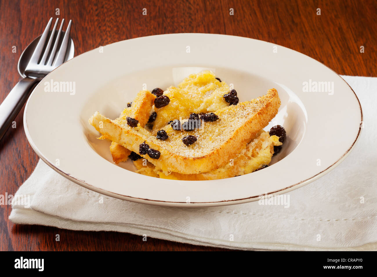 A serving of homely bread and butter pudding. Stock Photo