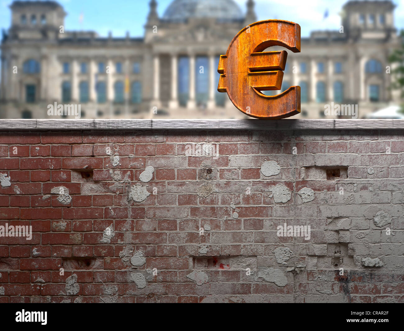 Rusty euro sign on a wall in front of the Reichstag building, Berlin