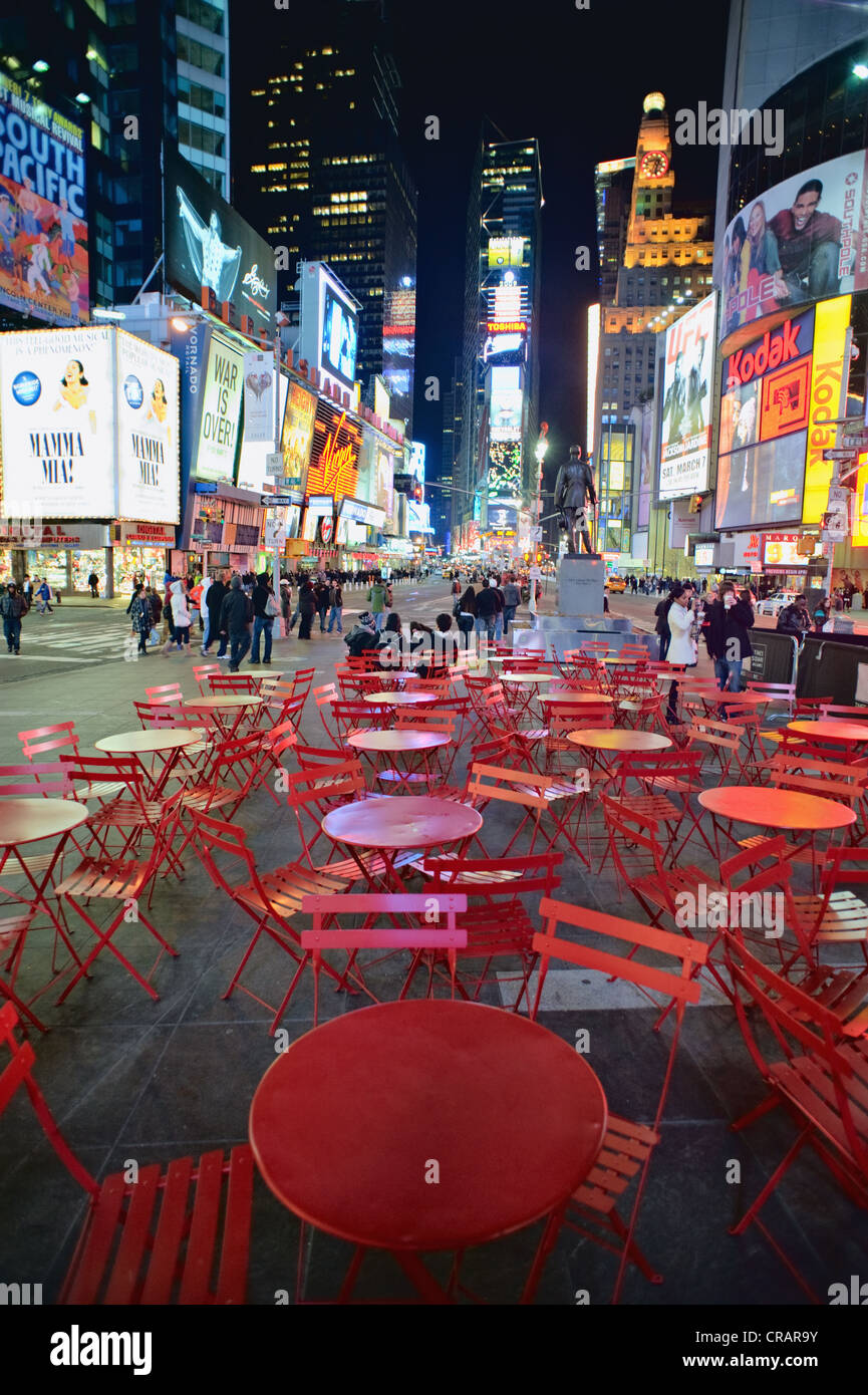 Red tables and chairs in Times Square, New York, night, 2009 Stock