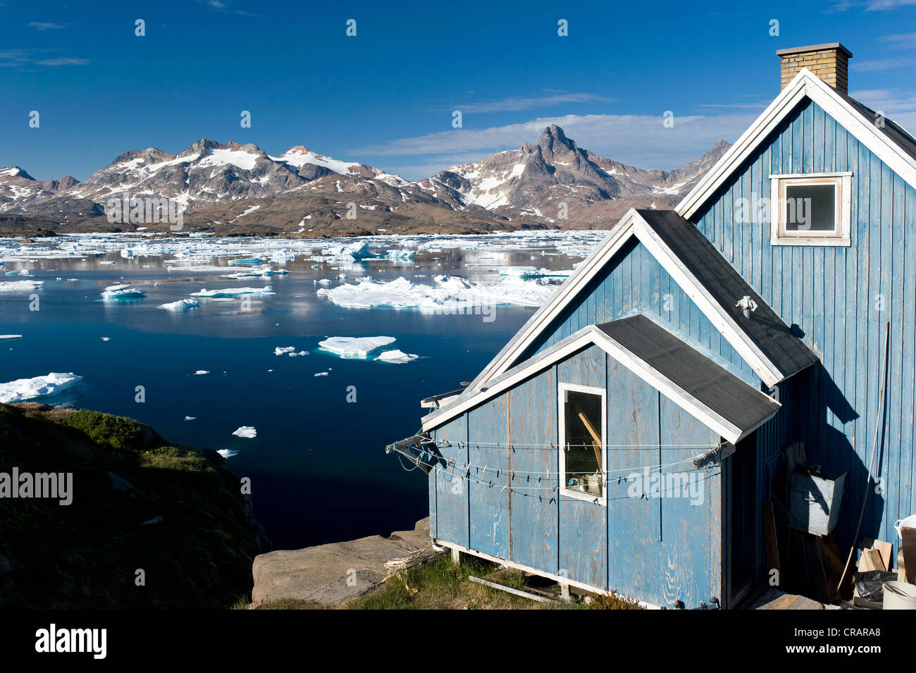 House by the fjord, Tasiilaq or Ammassalik, East Greenland, Greenland Stock Photo