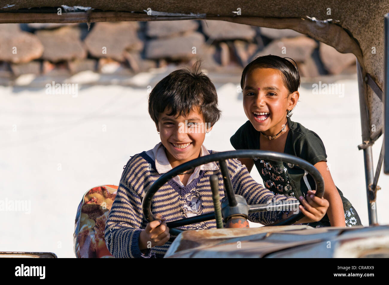 Children playing with a farm tractor, Orchha, Madhya Pradesh, northern India, India, Asia Stock Photo