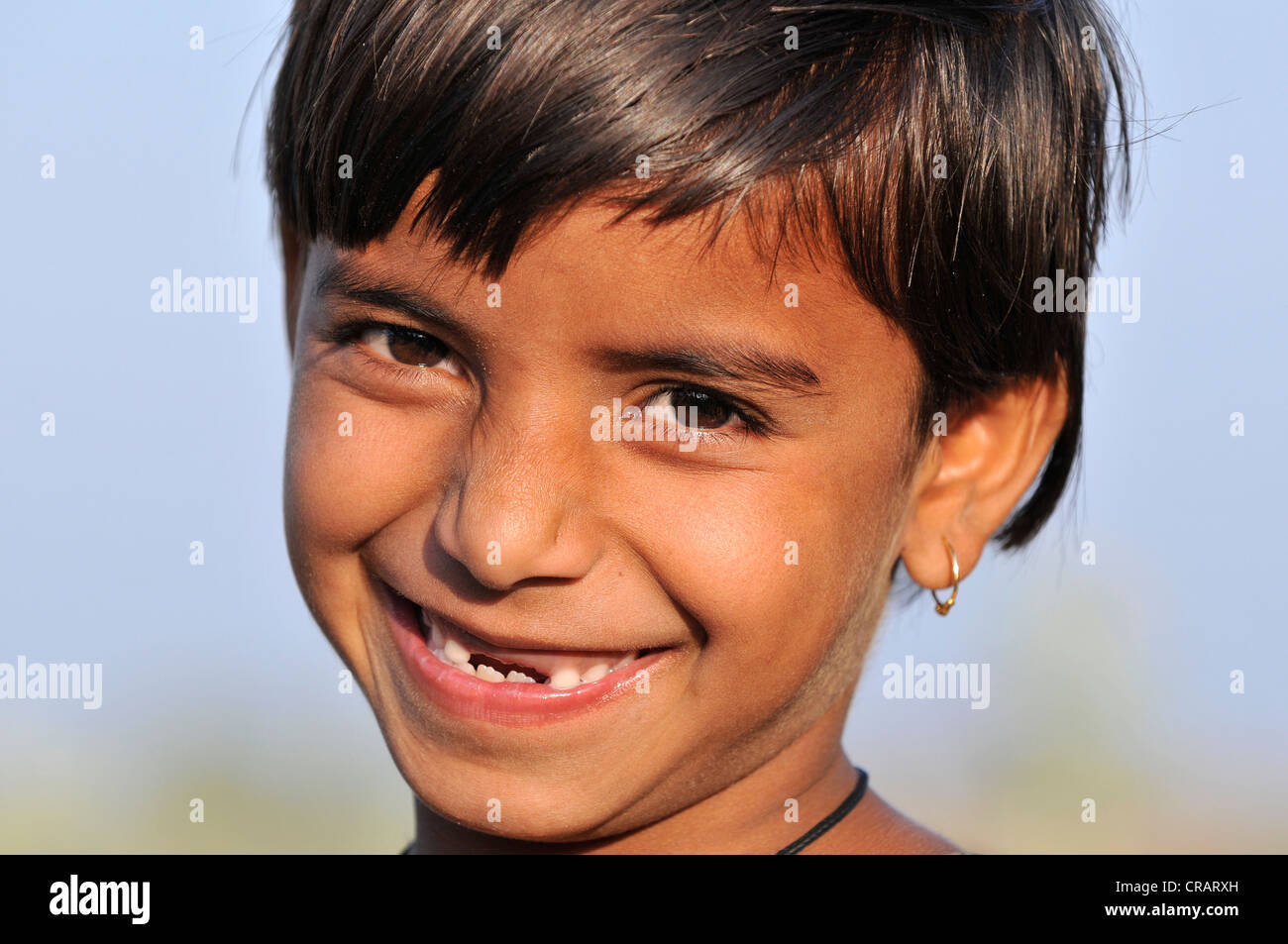Girl with missing teeth, portrait, Orchha, Madhya Pradesh, northern India, India, Asia Stock Photo