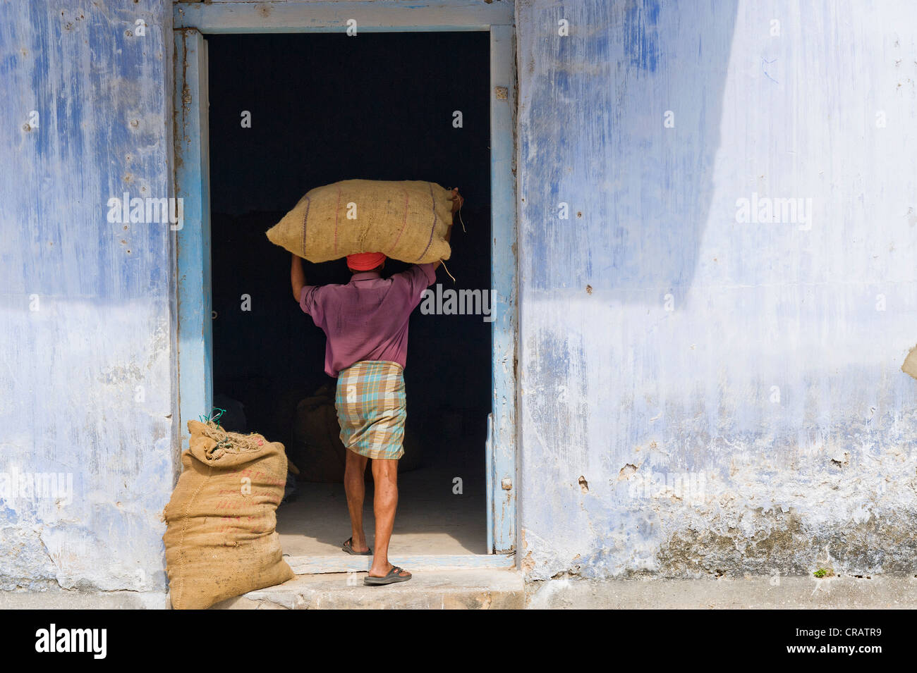 Worker carrying a bag of spices into a storehouse, Jew Town, Kochi, Kerala, southern India, India, Asia Stock Photo