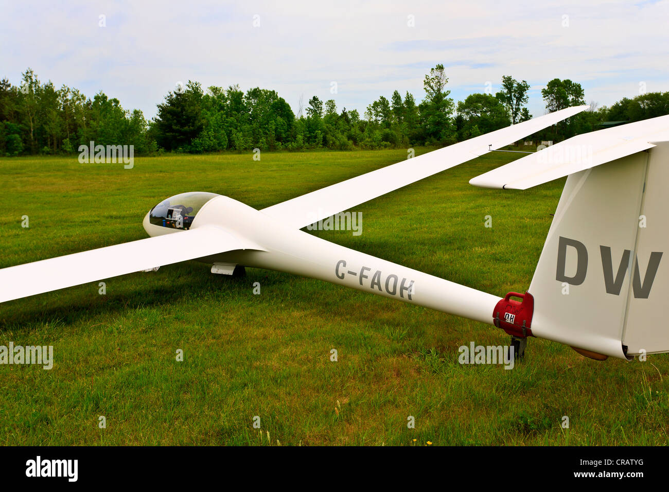Glider on grass runway Stock Photo