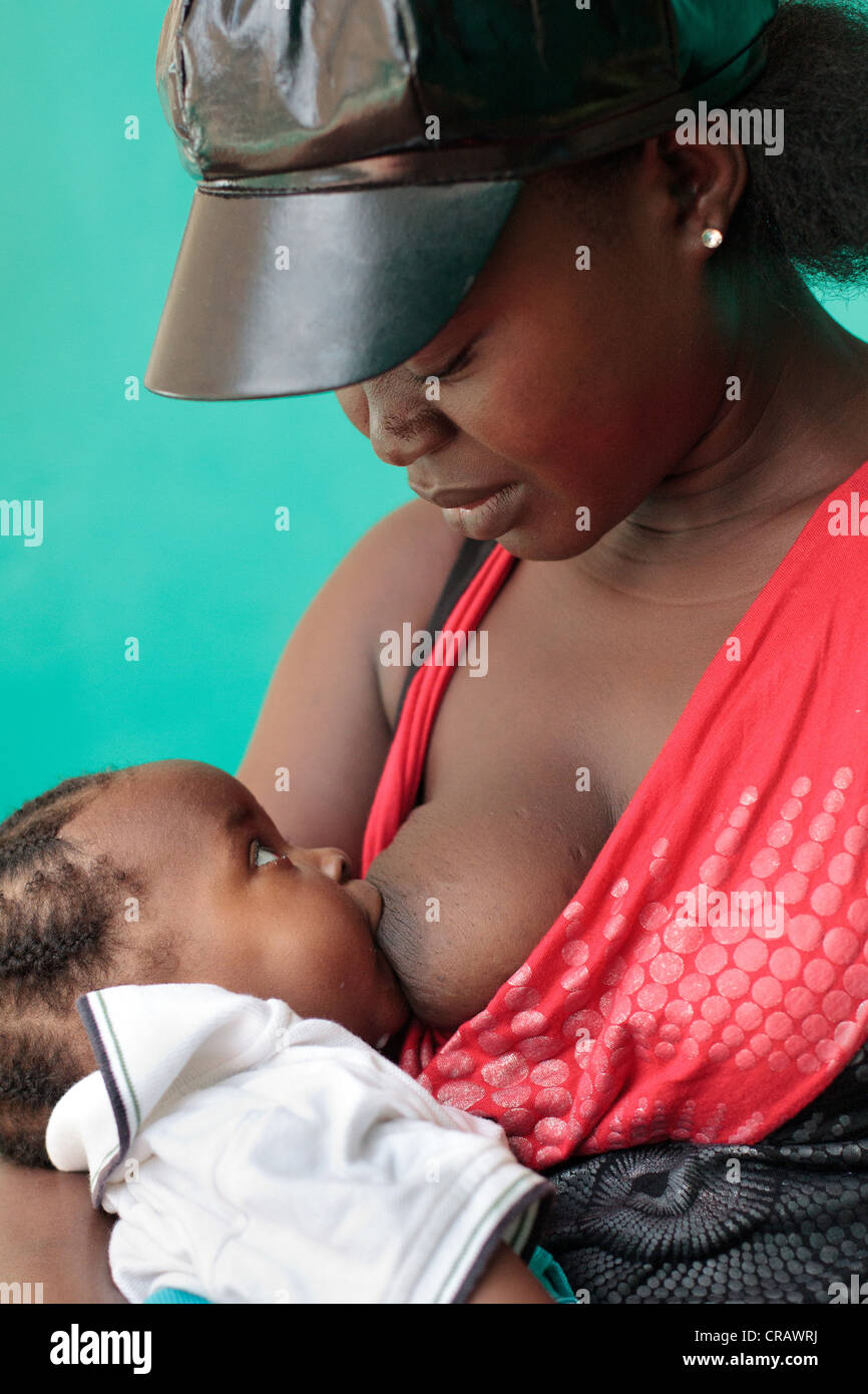 A woman breastfeeds her daughter at the Pipeline health center in Monrovia, Montserrado county, Liberia on Monday April 2, 2012. Stock Photo