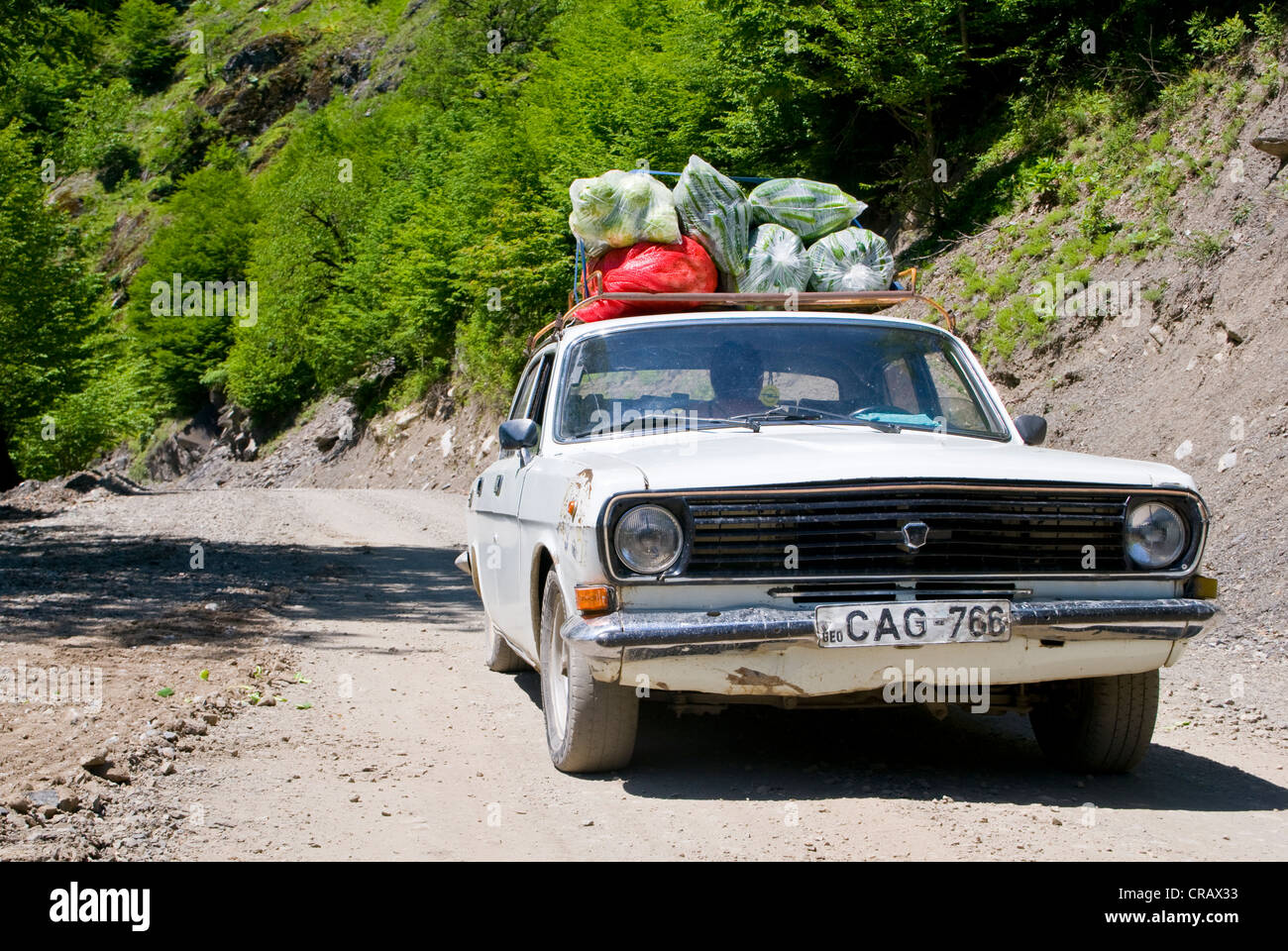 Overloaded car on its way to the Svaneti province, Georgia, Caucasus region, Middle East Stock Photo