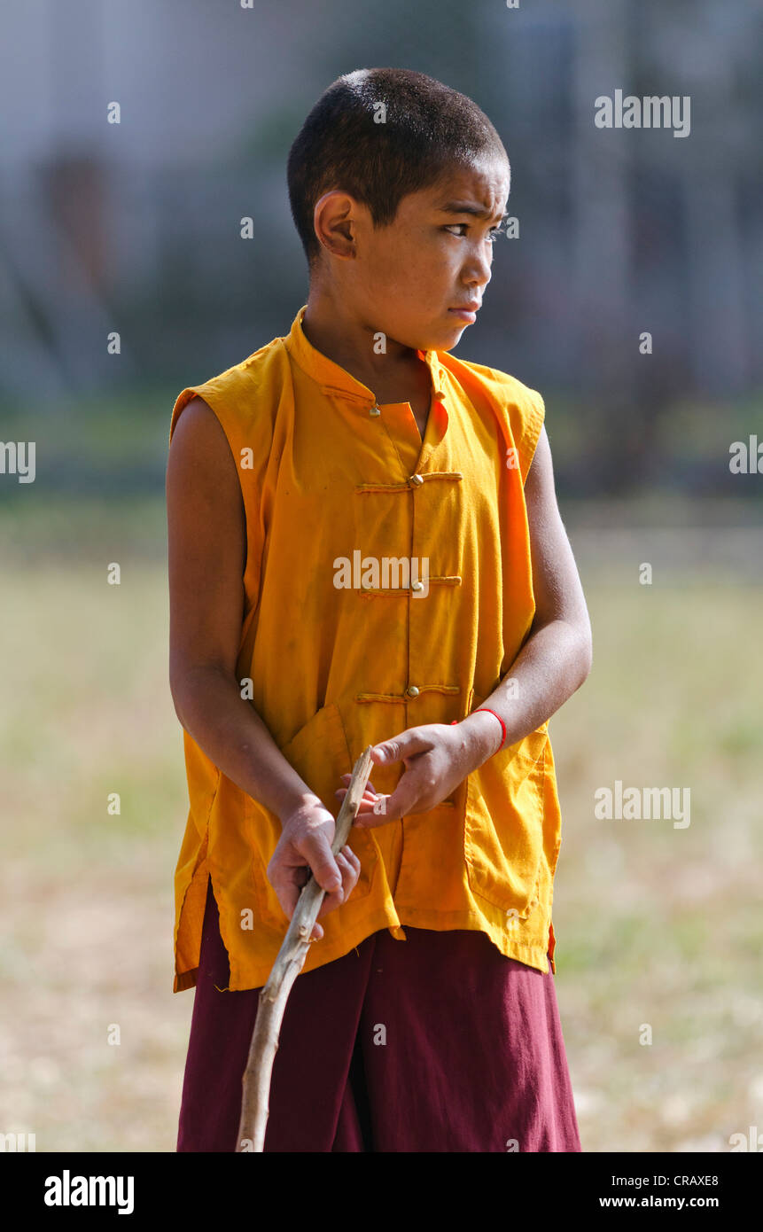 Young monk playing, Tibetan refugee settlement in Bylakuppe, Mysore District, Karnataka, South India, India, Asia Stock Photo