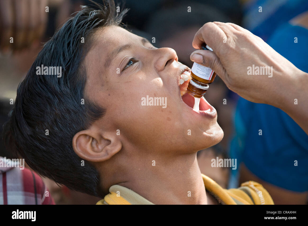 Boy getting an oral vaccination, vaccination campaign for children by the German Doctors for Developing Countries in Calcutta, Stock Photo