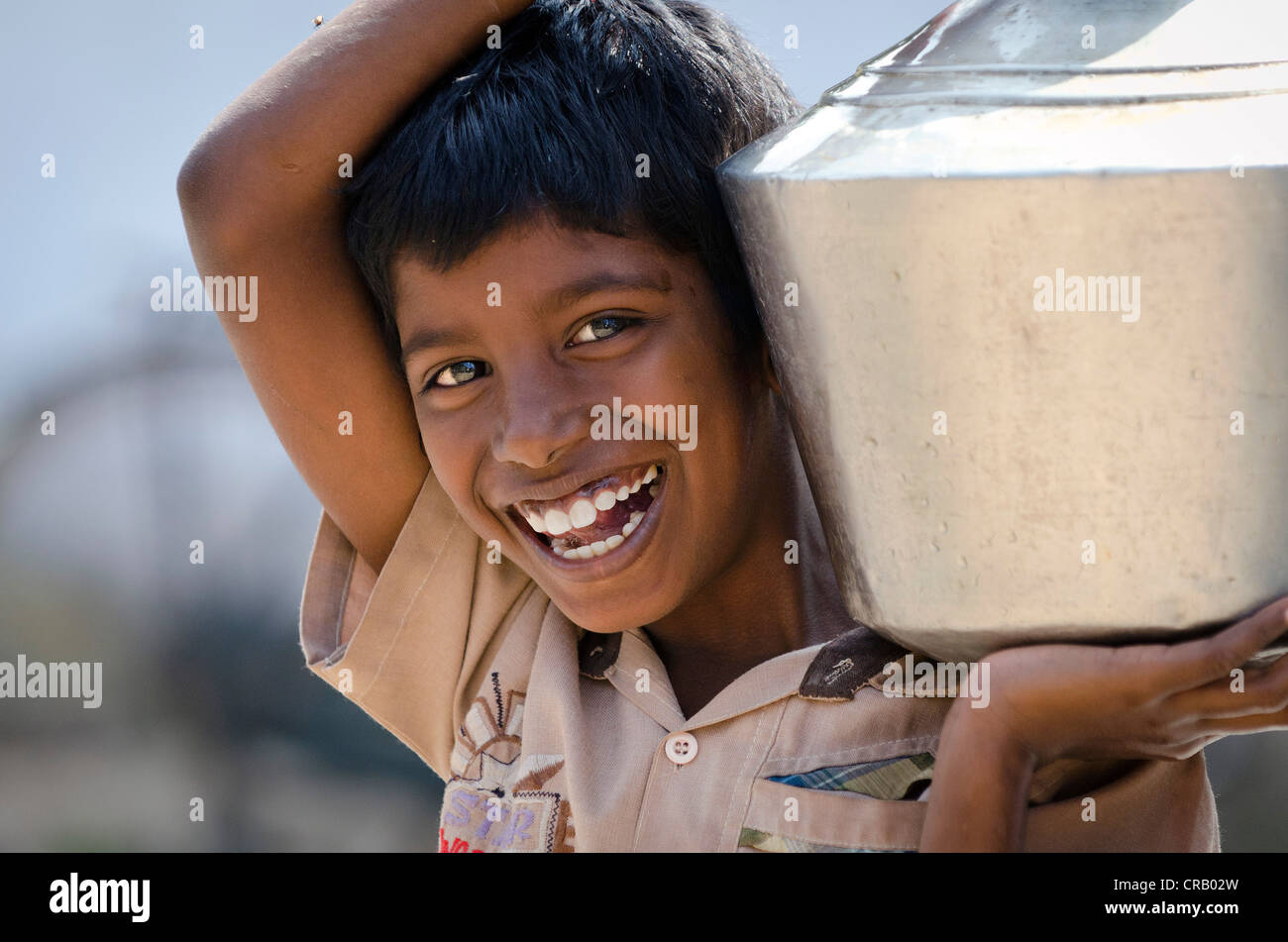 Boy with water tank, Sevandhipalayam, near Karur, Tamil Nadu, India, Asia Stock Photo