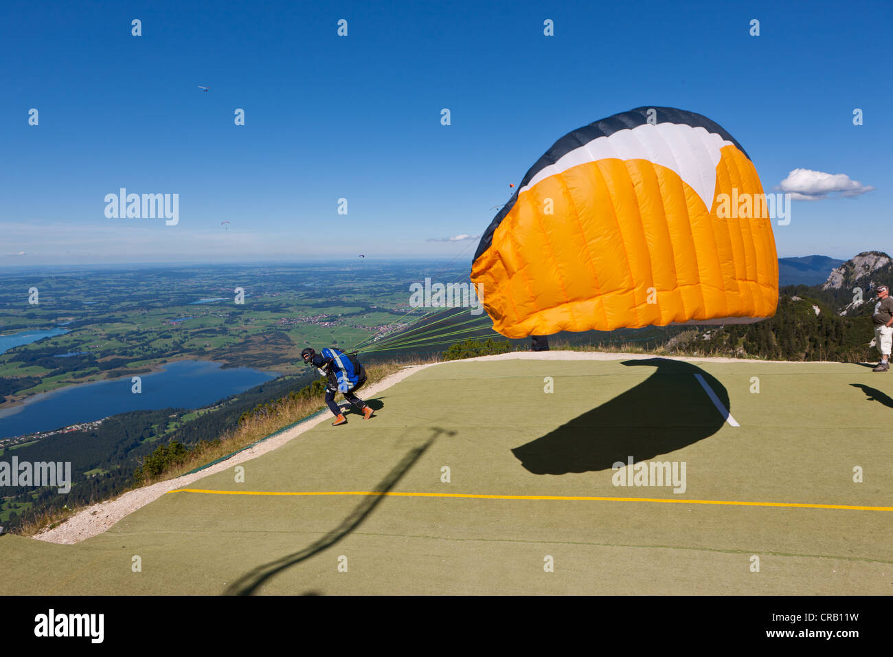 Hang glider taking off, Mt Tegelberg, Froggensee Lake at back, Upper
