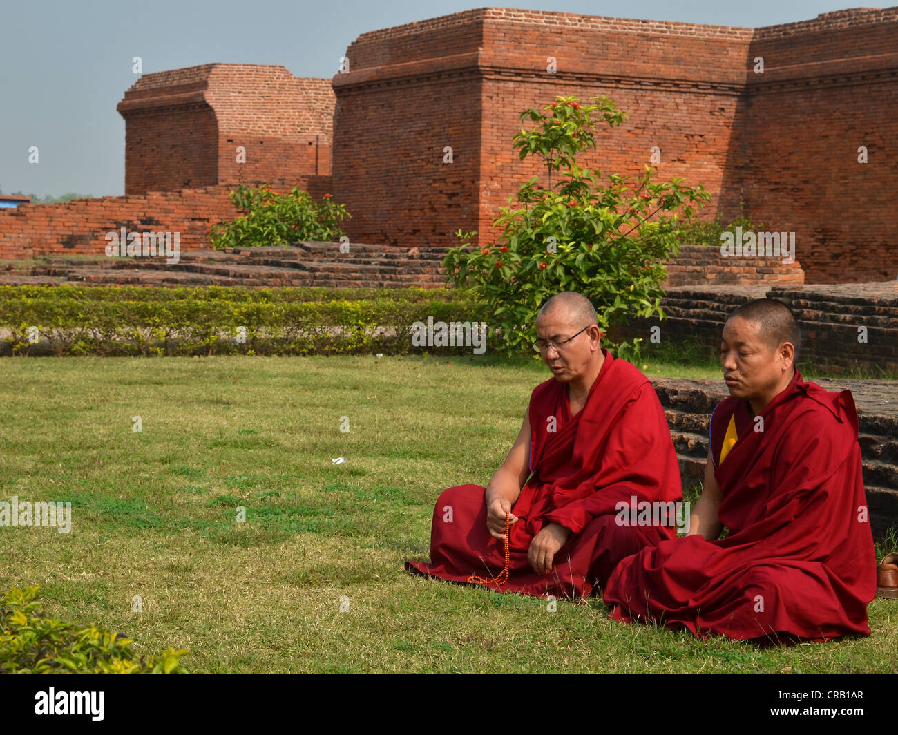 Buddhism, Tibetan monks in red robes in meditation and prayer during ...