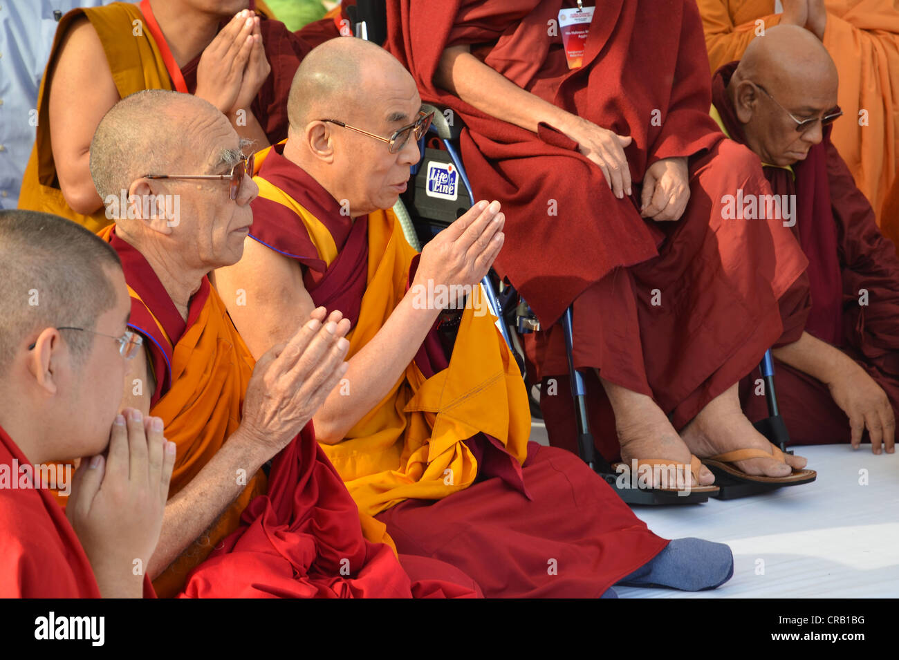 Buddhism, the Dalai Lama in a communal prayer with dignitaries, eg