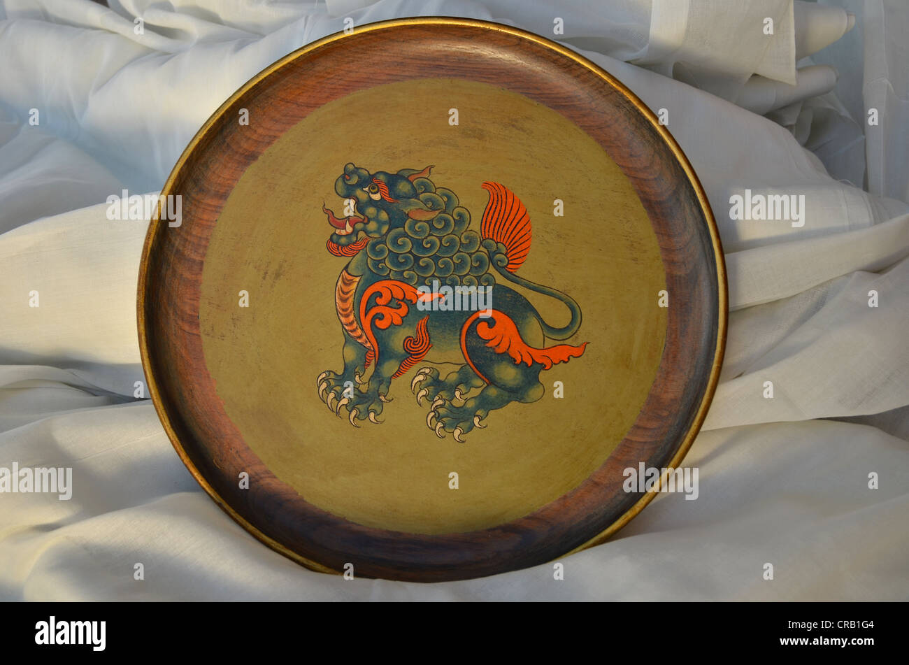 Tibetan handicrafts, Tibetan wooden plate with lacquer painting, depicting a mystical dragon, traditional Tibetan wood art Stock Photo