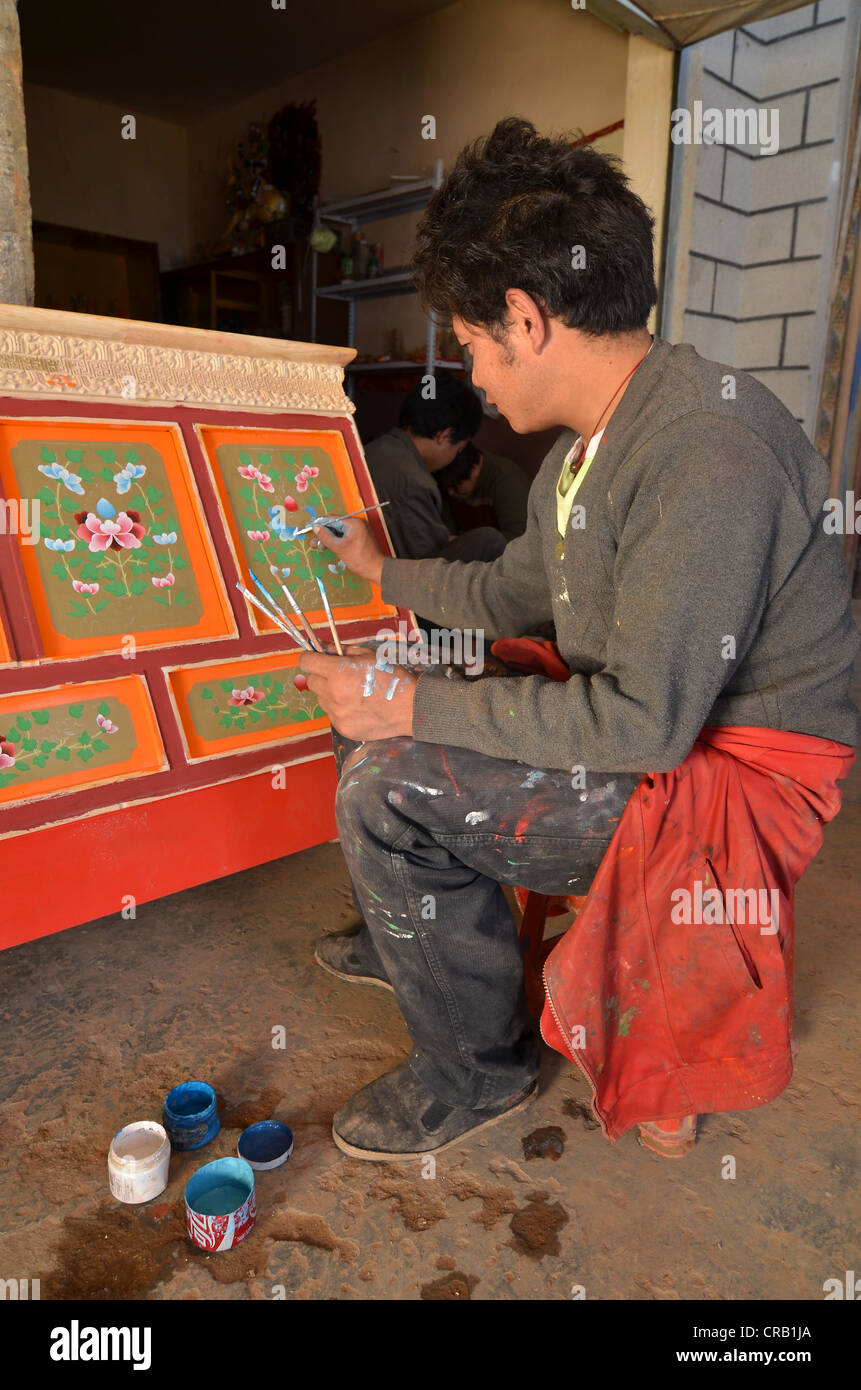 Tibetan handicrafts, carpenter painting a typical Tibetan wooden