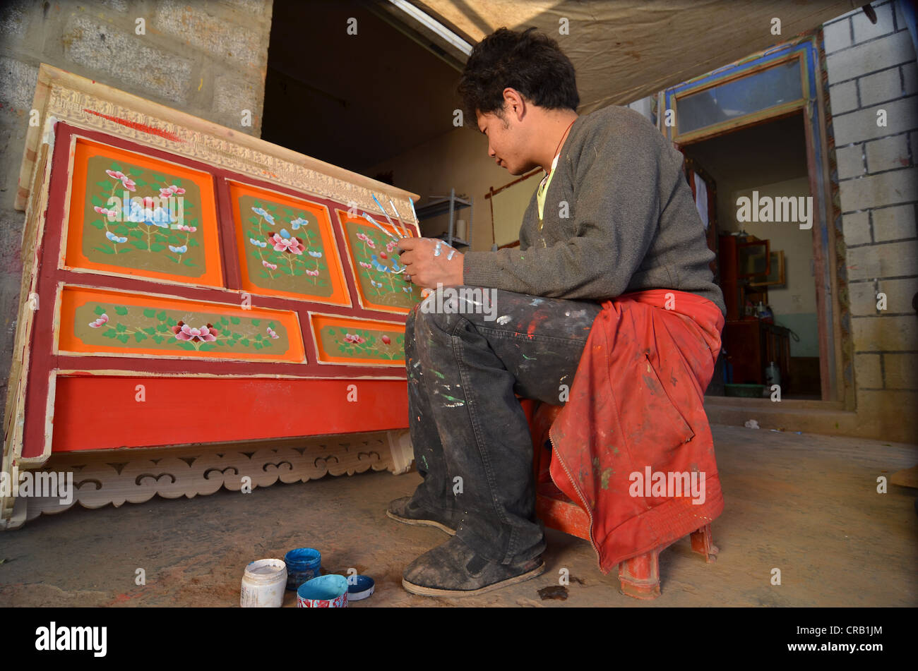 Tibetan handicrafts, carpenter painting a typical Tibetan wooden