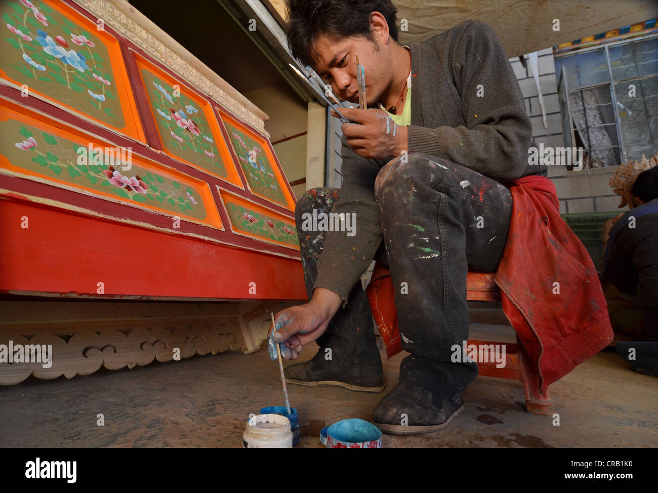 Tibetan handicrafts, carpenter painting a typical Tibetan wooden