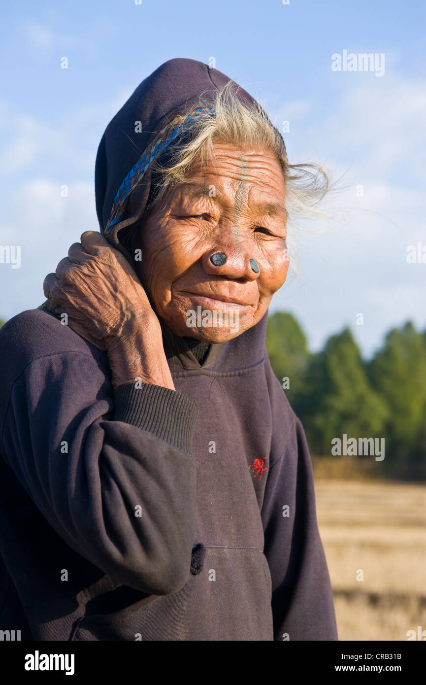 Elderly woman of the Apatani ethnic group, known for the pieces of wood in their nose to make them less attractive to rival Stock Photo