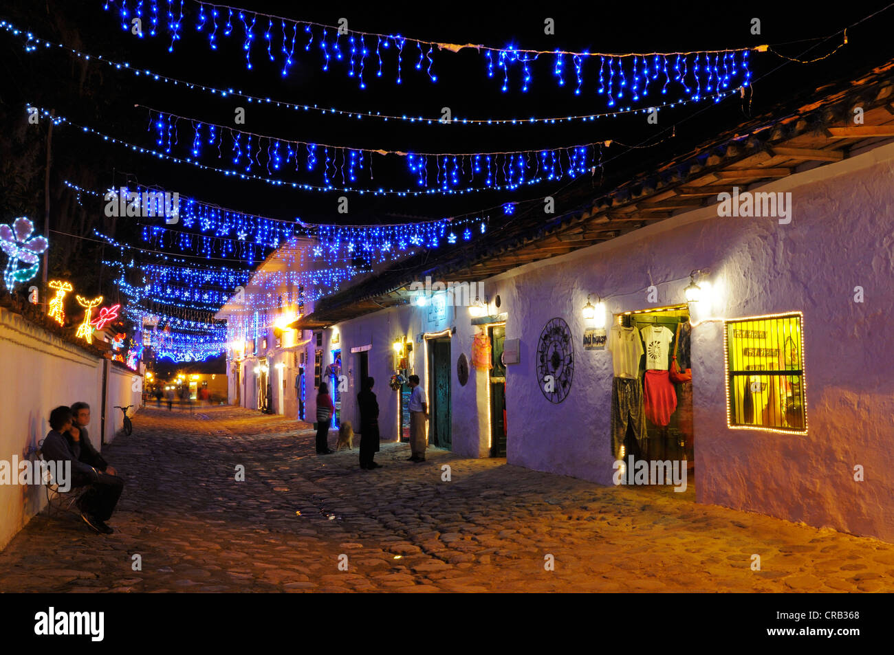 Alleyway with chains of lights in Villa de Leyva in the evening, colonial buildings, Boyaca department, Colombia, South America Stock Photo