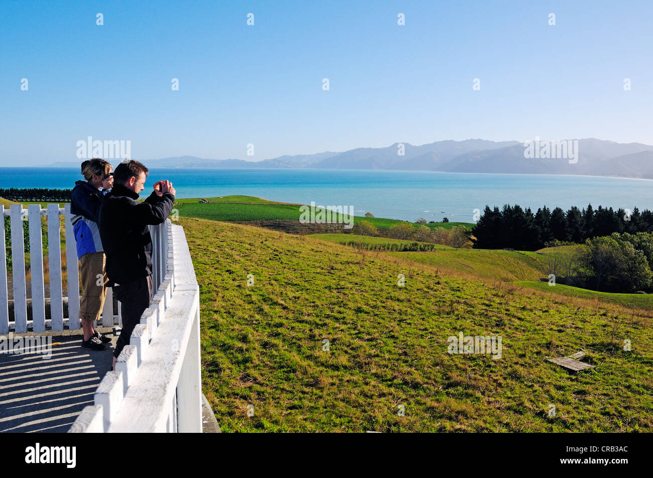 Tourists taking pictures at a viewpoint in Kaikoura, Seaward Kaikoura Ranges, South Island, New Zealand Stock Photo