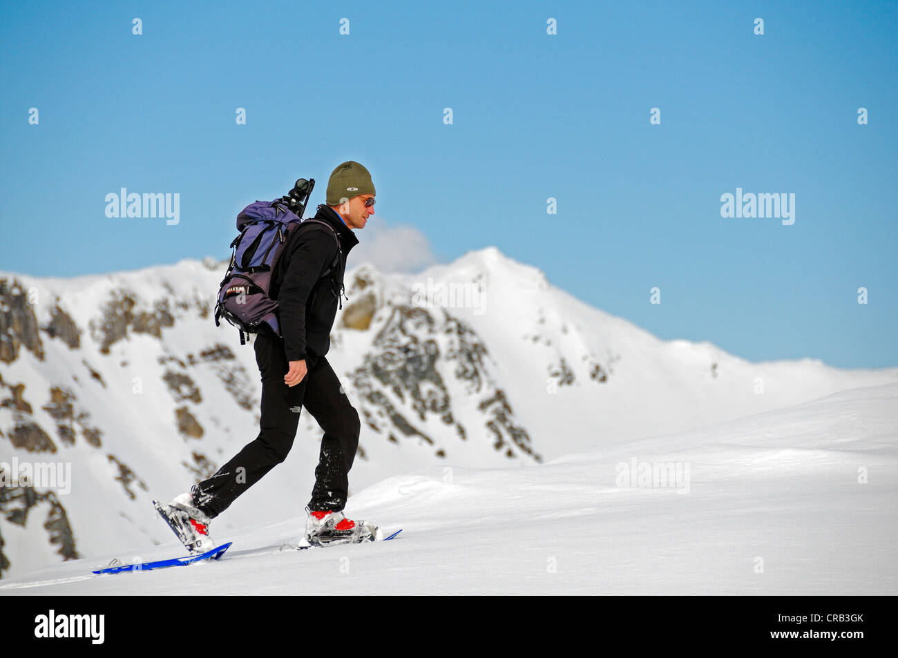 National Park Ranger hiking with snowshoes on Mount Schareck, National Park Hohe Tauern, Carinthia, Austria, Europe Stock Photo