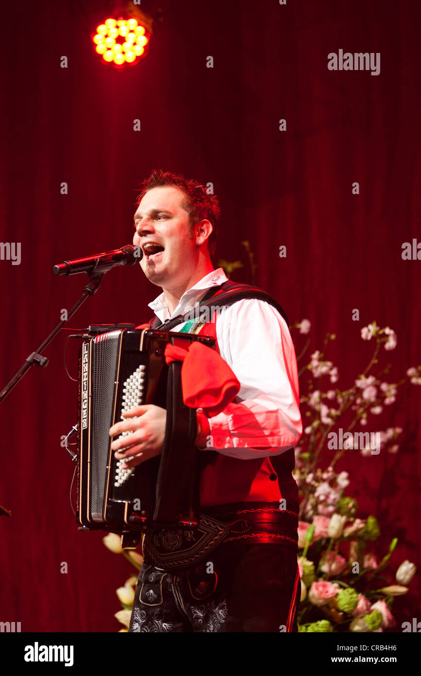 Michael Ringler, accordionist of the Austrian folk music and pop band 'Die jungen Zillertaler' performing live at the Schlager Stock Photo