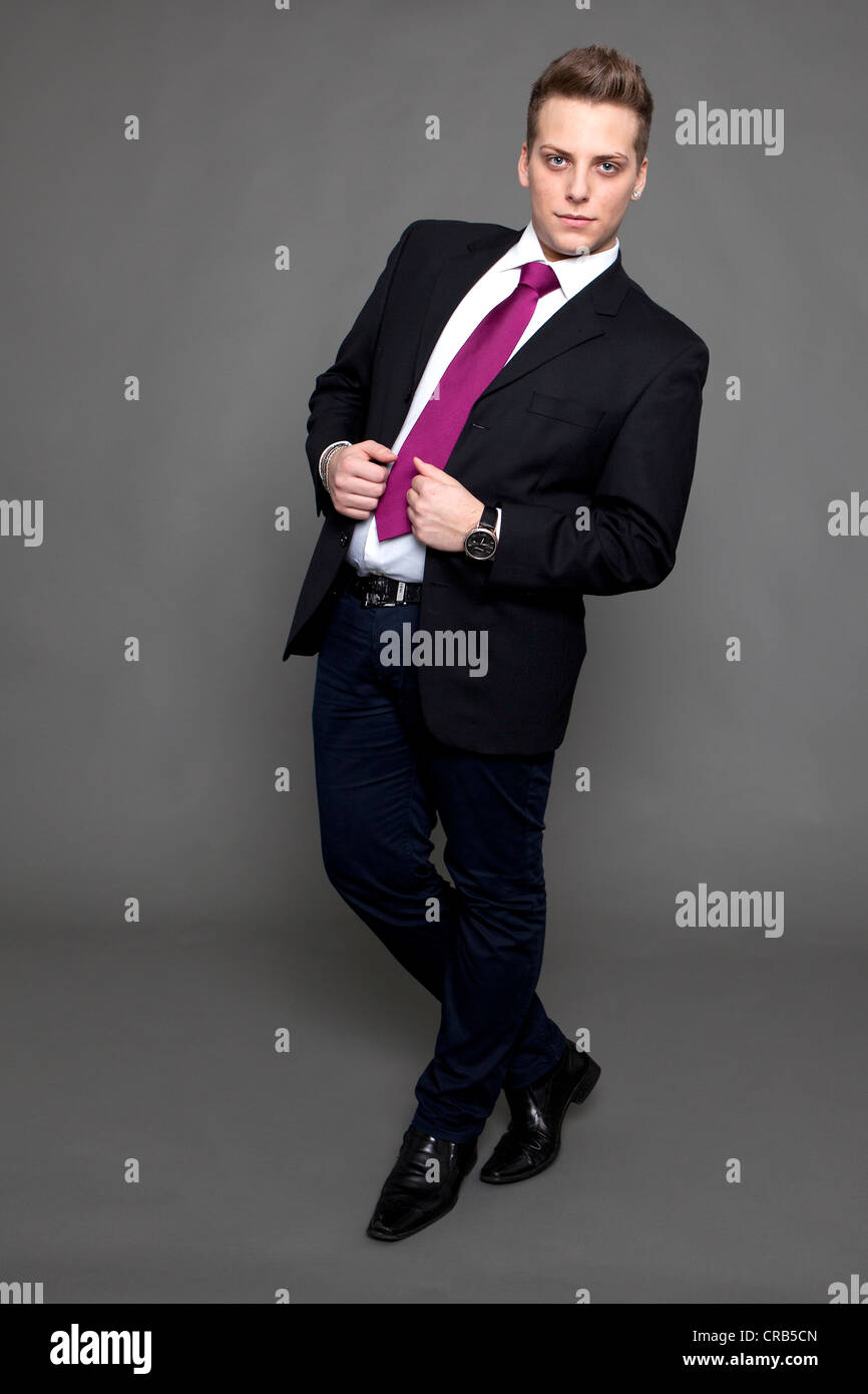 Young man in a suit and a tie, business attire Stock Photo - Alamy