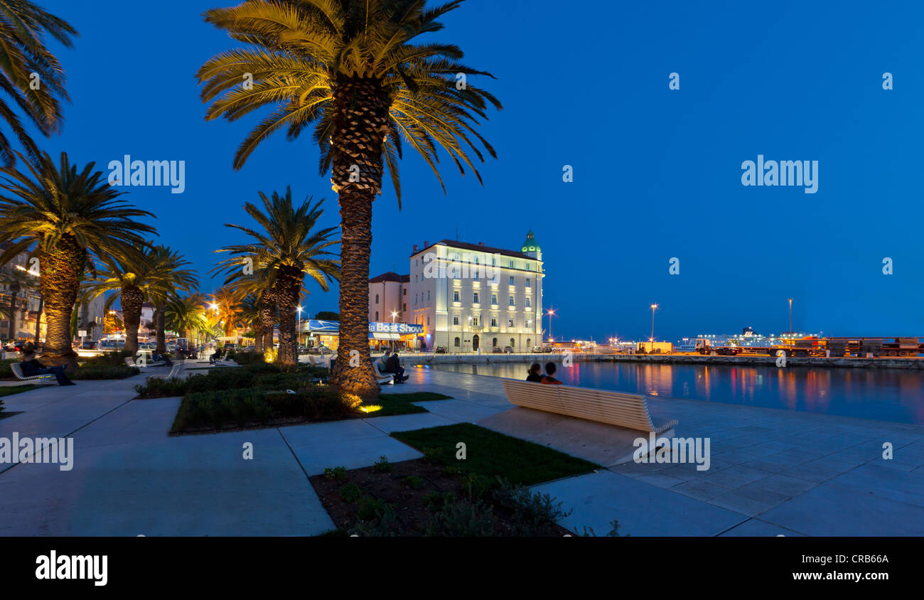 Split, Croatia: The Riva promenade at dusk, lined with palm trees and historic buildings, overlooking the Adriatic Sea