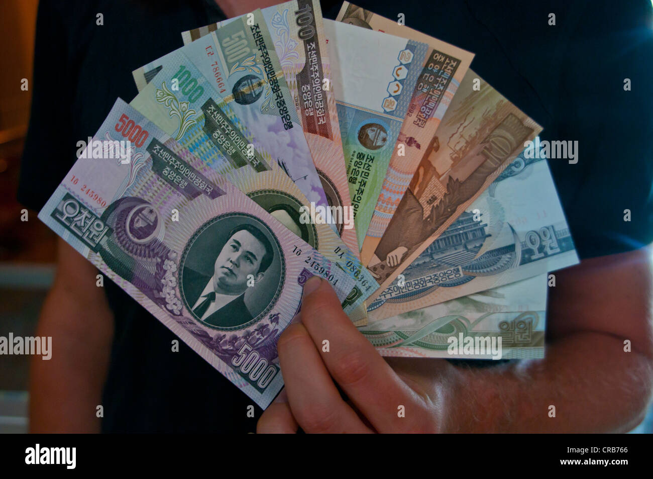 Person holding a fan of North Korean banknotes Stock Photo