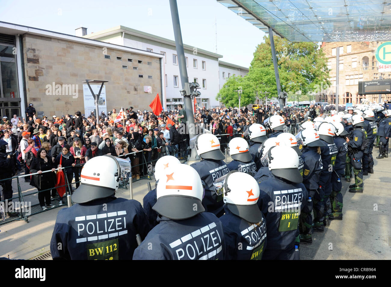 1st May rally, police officers holding leftist protesters at bay at the railway station, Heilbronn, Baden-Wuerttemberg Stock Photo