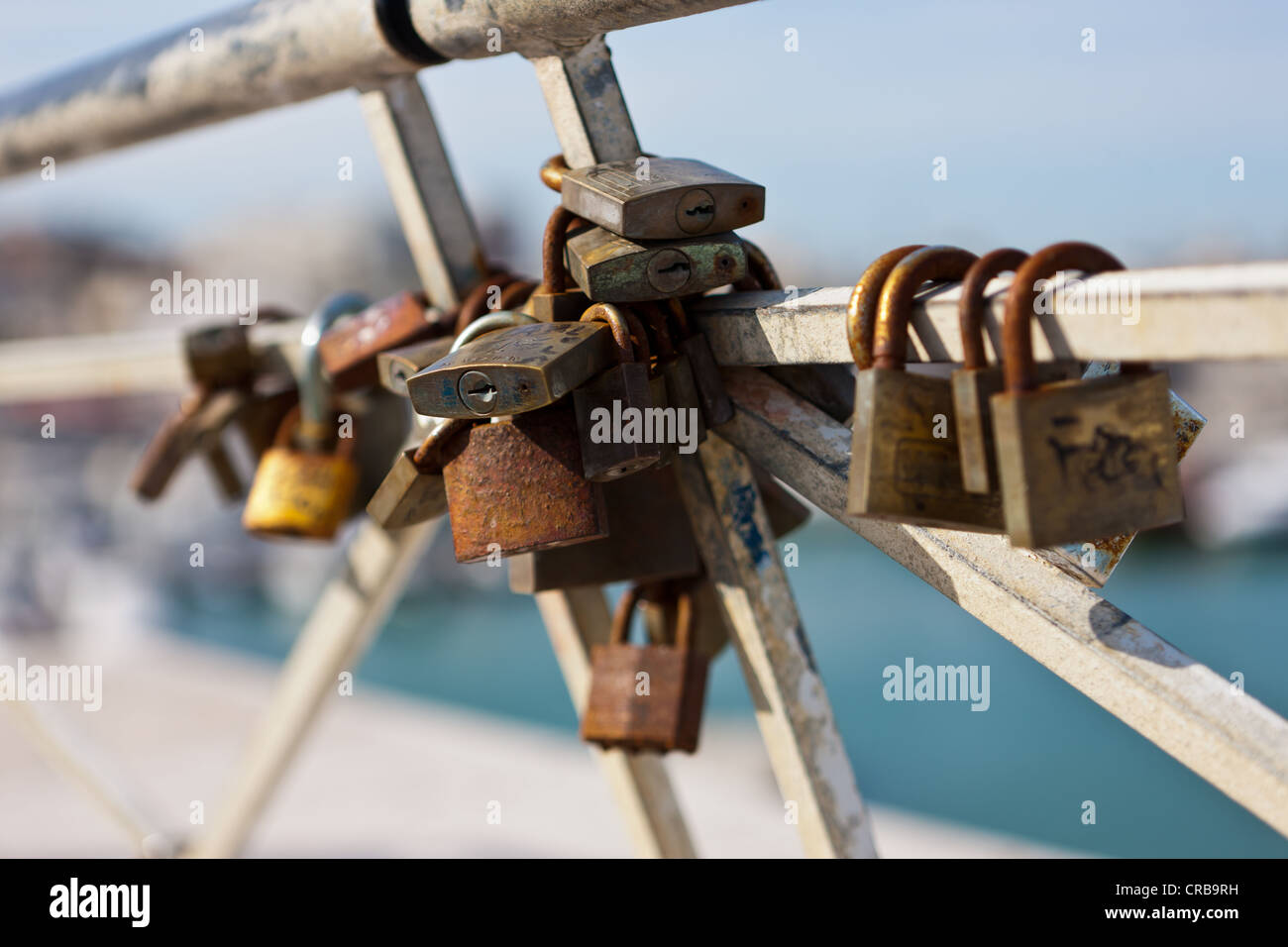 Old rusty padlocks on a railing Stock Photo - Alamy