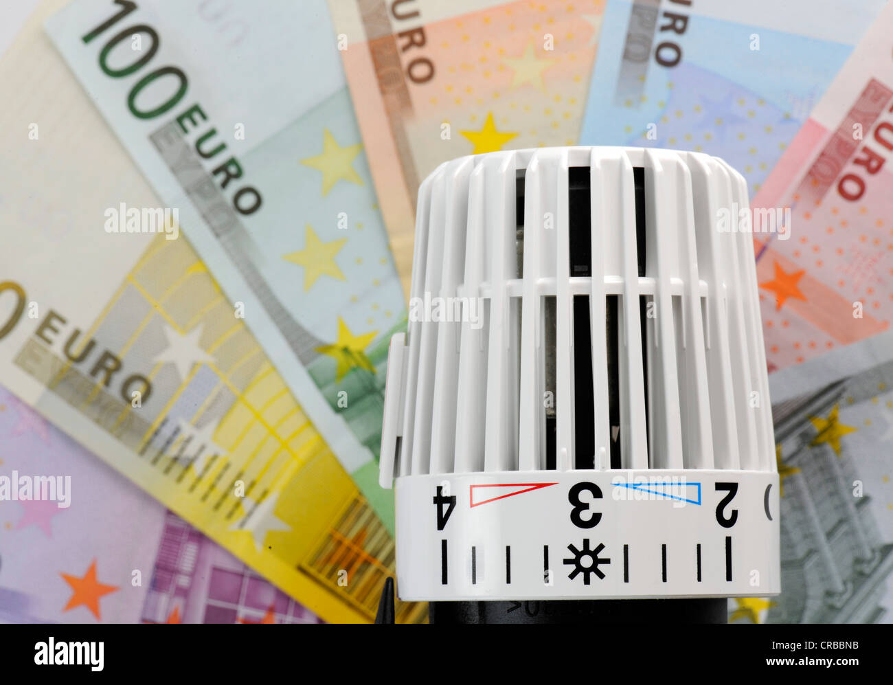Thermostatic central heating valve, radiator valve, hot and cold marks, on euro banknotes, symbolic images for heating and Stock Photo