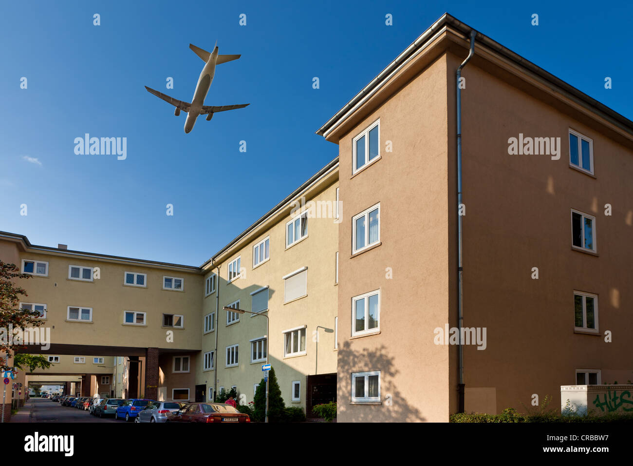Aircraft flying over residential buildings, aircraft noise in residential areas, digital composing, Frankfurt, Hesse Stock Photo