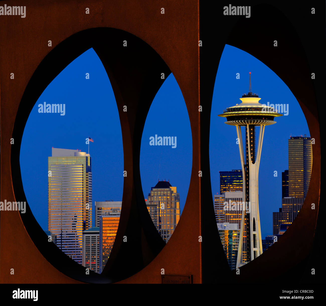 View through steel sculpture 'Changing Form' by Doris Chase, night view, skyline of Seattle financial district with Space Needle Stock Photo