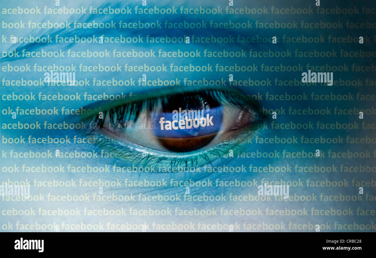 Eye looking at a computer with the Facebook logo, symbolic image Stock Photo