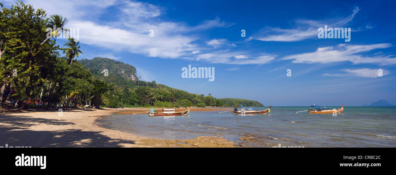 Long-tail boats on palm beach, Ko Muk or Ko Mook island, Thailand, Southeast Asia Stock Photo