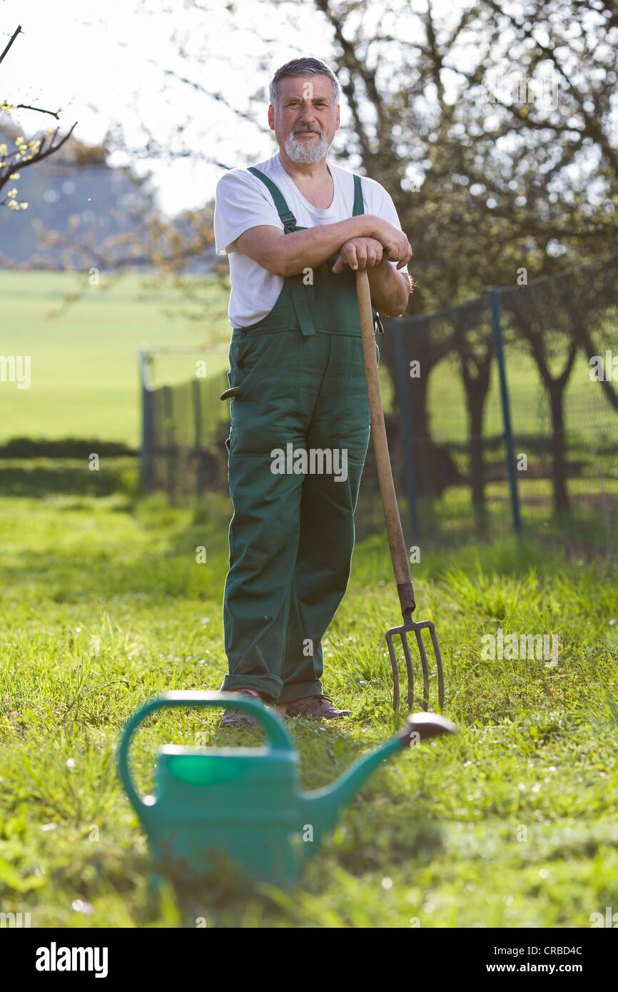 portrait of a senior man gardening in his garden Stock Photo - Alamy