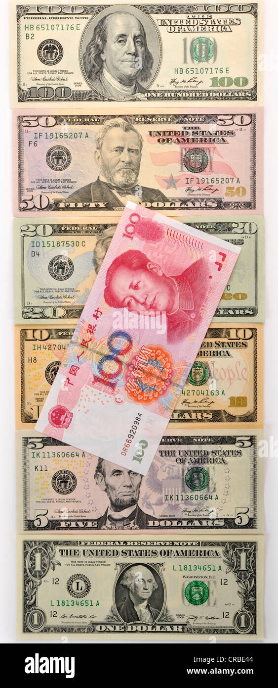 Symbolic image for exchange rates, U.S. dollar banknotes and a Chinese yuan, renminbi, currency of the People's Republic of Stock Photo