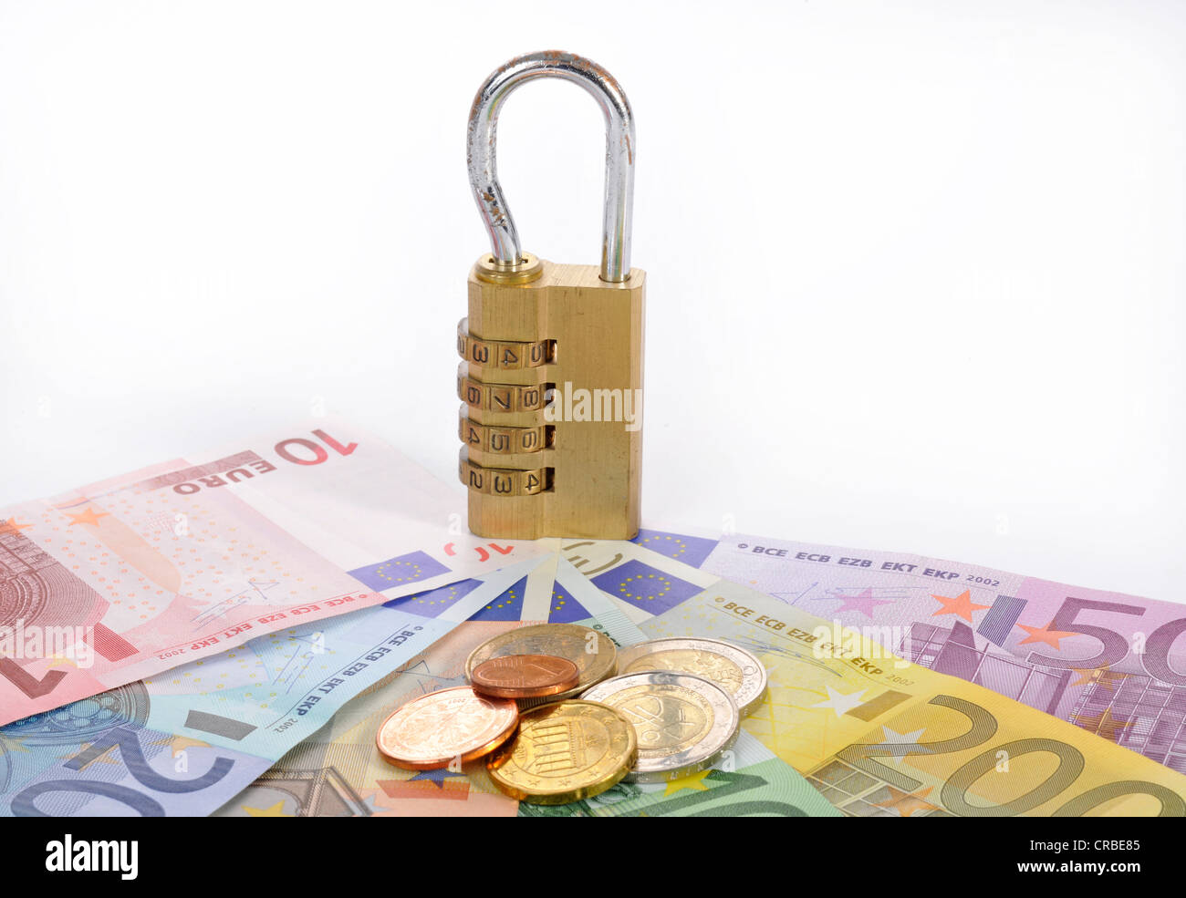 Combination lock on euro banknotes and coins, symbolic image of monetary security Stock Photo