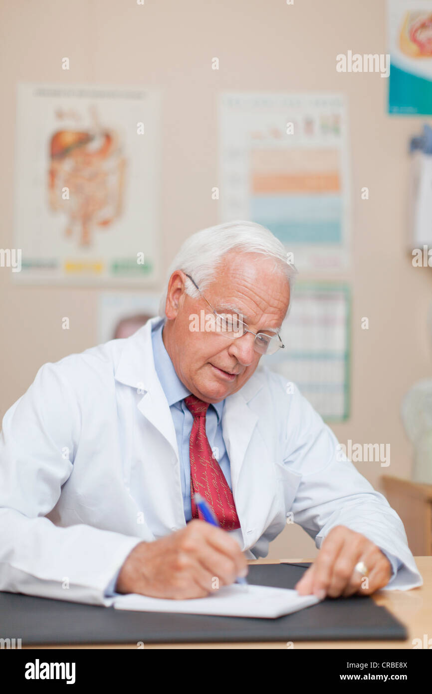 Doctor writing notes in office Stock Photo
