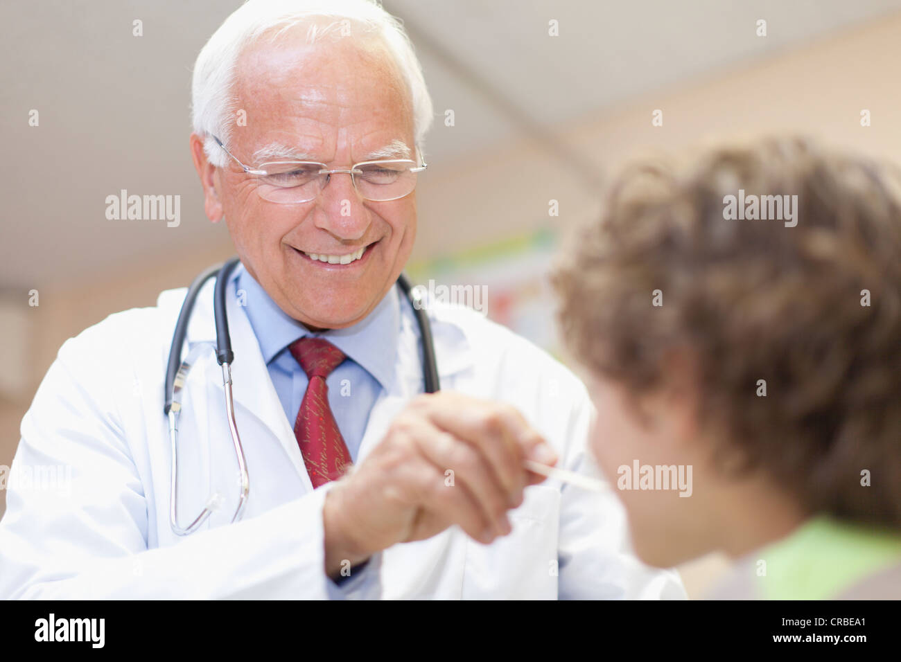 Doctor Examining Boy In Office Stock Photo Alamy